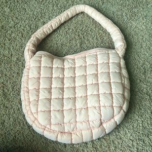 Small light pink puffer bag.